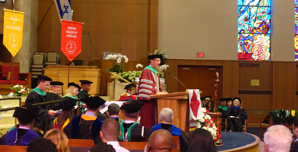 dr. mittelman speaking at commencement