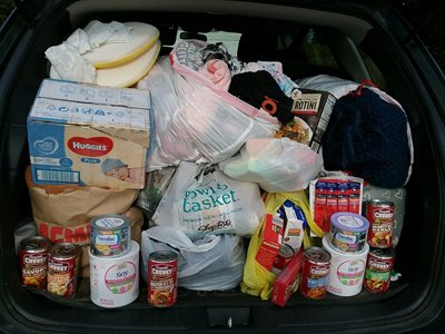 The donations from the cradle of hope drive in the trunk of a car