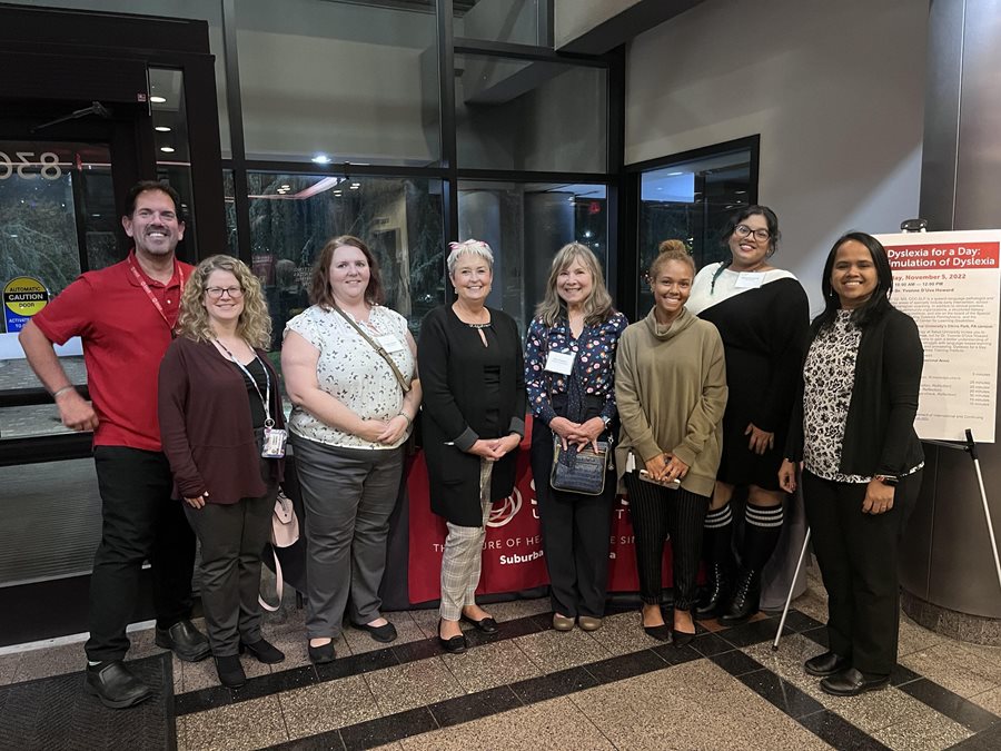 Robert Serianni and Radhika Aravamudhan with the CSD Advisors in the main lobby of Salus University