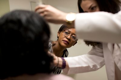 Optometrist working with patient