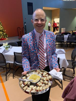 Don Kates serving food at the holiday party