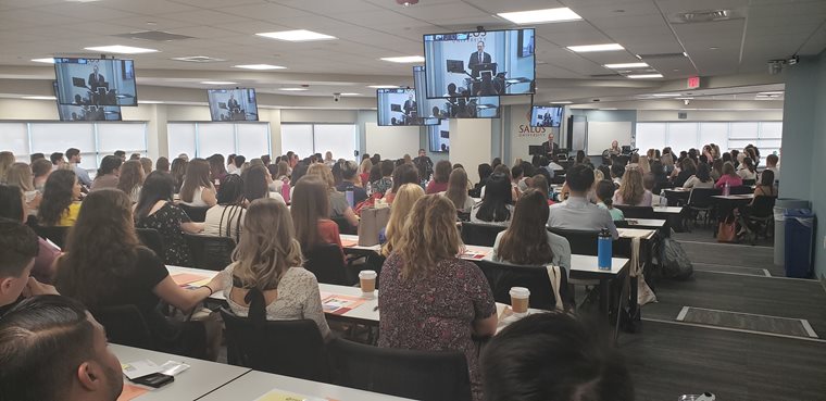 Dr. Mittelman speaking to new students