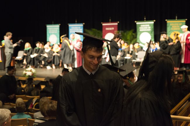 students walking up to the stage at commencement