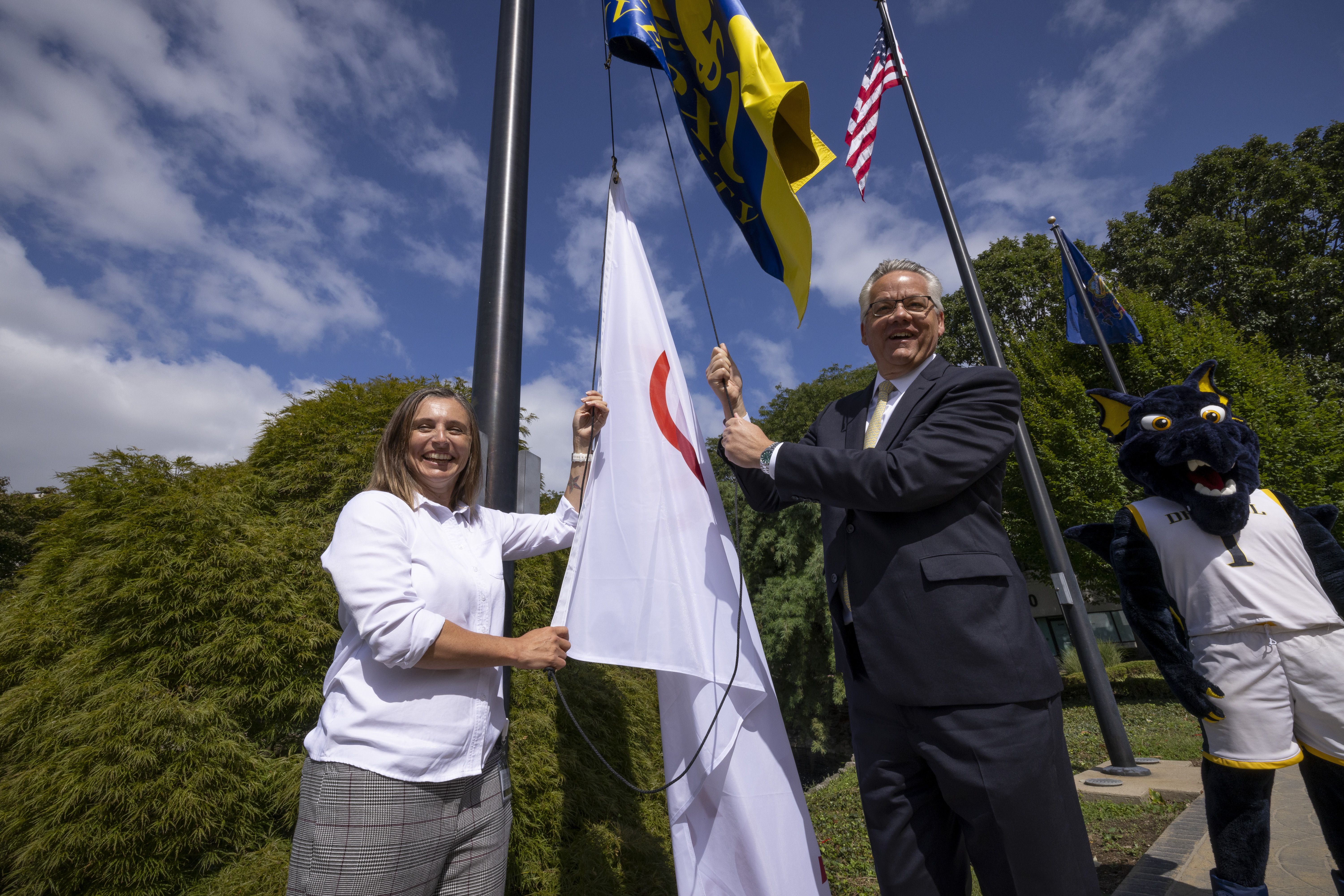 Dr. Myers and Dr. Jensen raising the flags