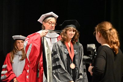 Graduate Morgan Glover getting her hood