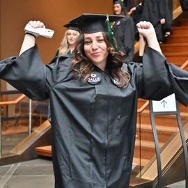 Graduate cheers walking into the auditorium