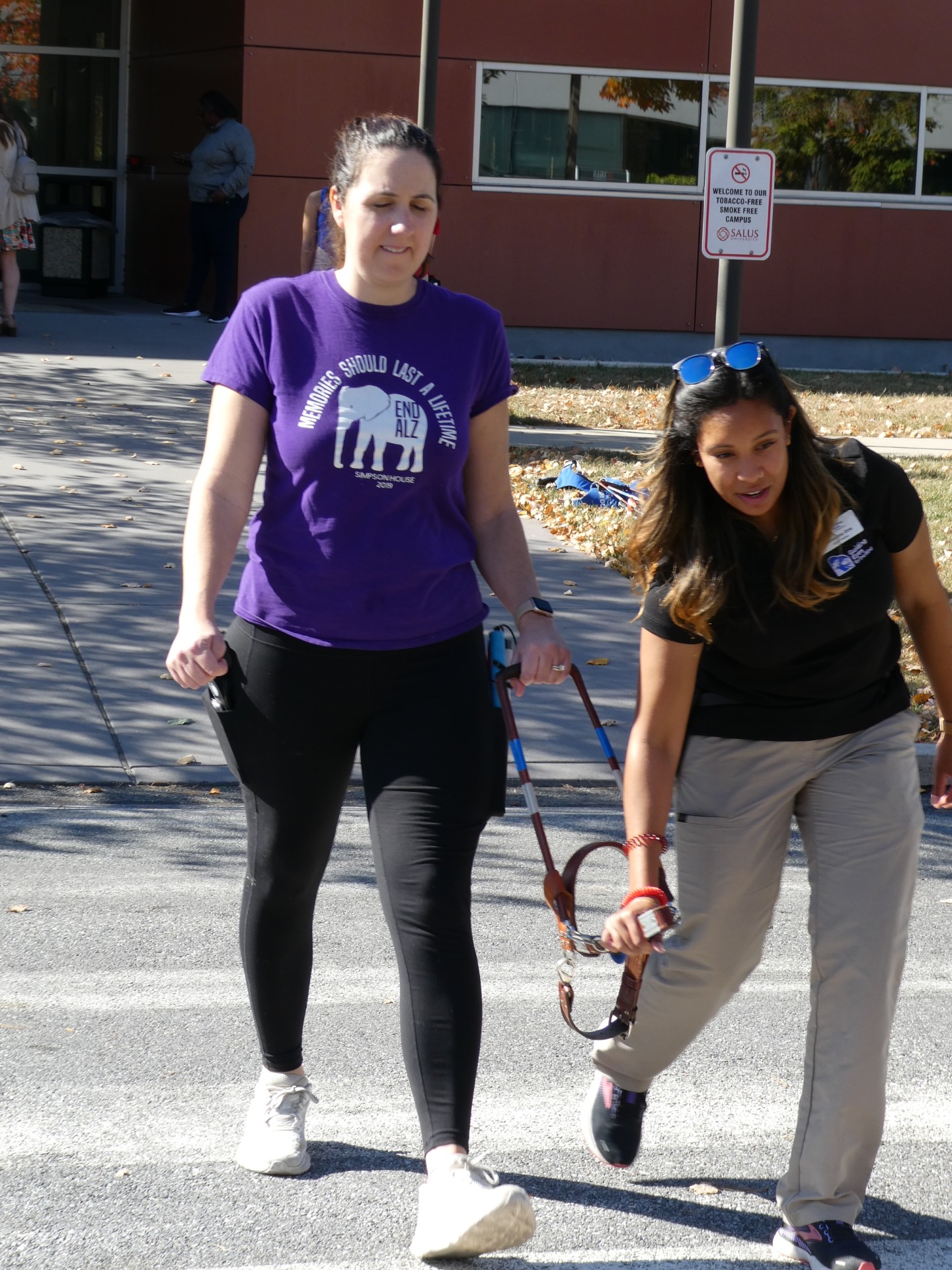 Christine Brennan with guide dog trainer crossing the street