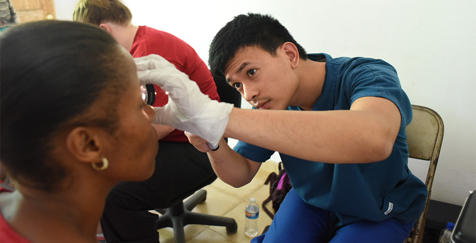 SOSH student performing eye exam