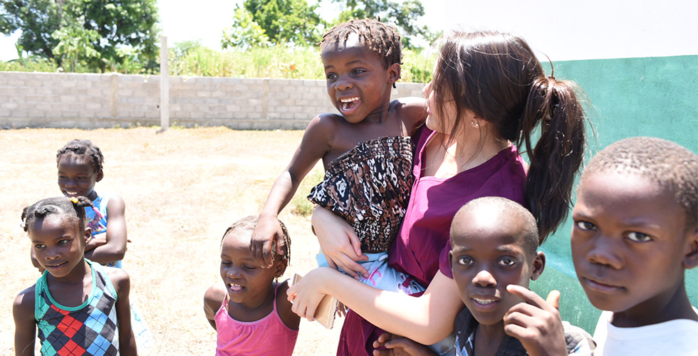 SOSH student with kids in Haiti