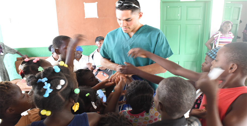 SOSH student with kids in Haiti