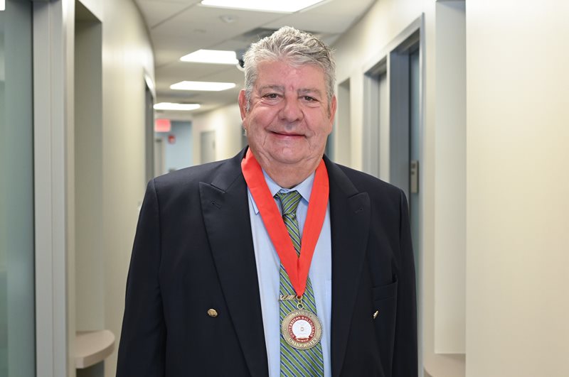 Headshot of Dr. John Fitzgerald wearing medal