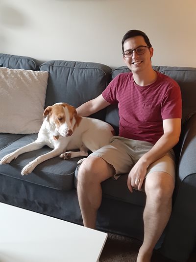 Dr. Nicholas Karbach and his dog sitting on a couch