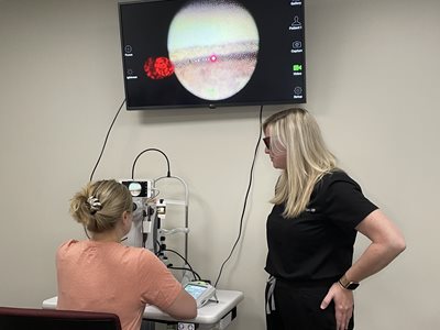 Dr. Coyne working with a student in the laser lab