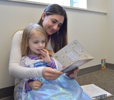 SLP student reading to child at SLI