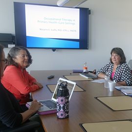 faculty members sitting at table