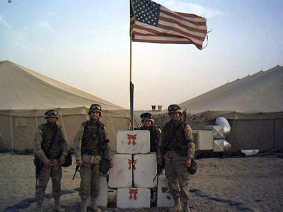 David Meltzer and fellow soldiers next to american flag