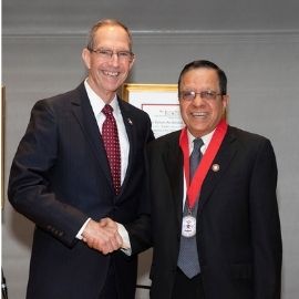 Dr. Mittelman and Dr. Verma shaking hands