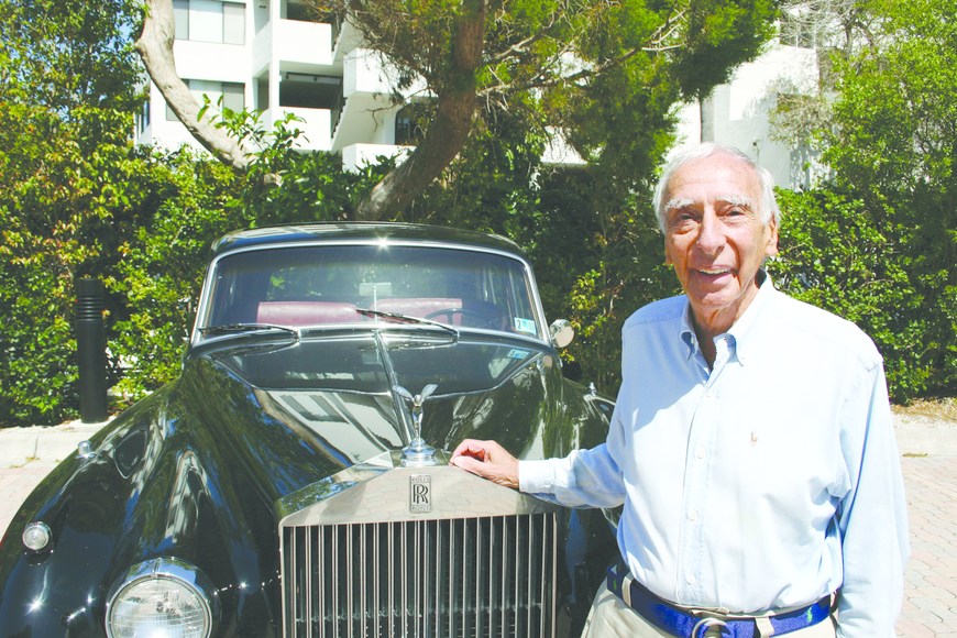 Dr. Robert J. Morrison standing in front of a car