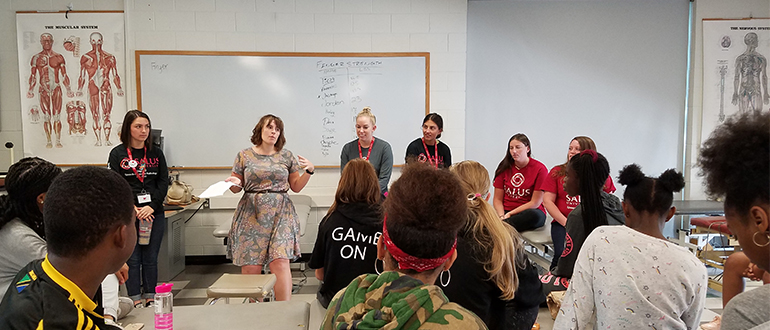 students speaking at a classroom