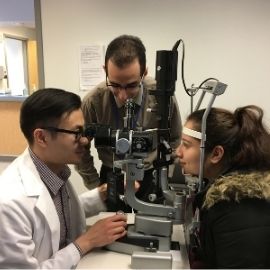 Optometrist working with patient