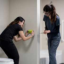 OT students making modifications in a house