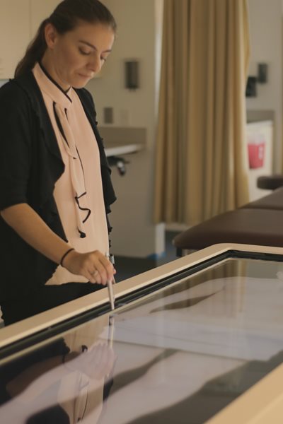 Faculty member using the simulation table