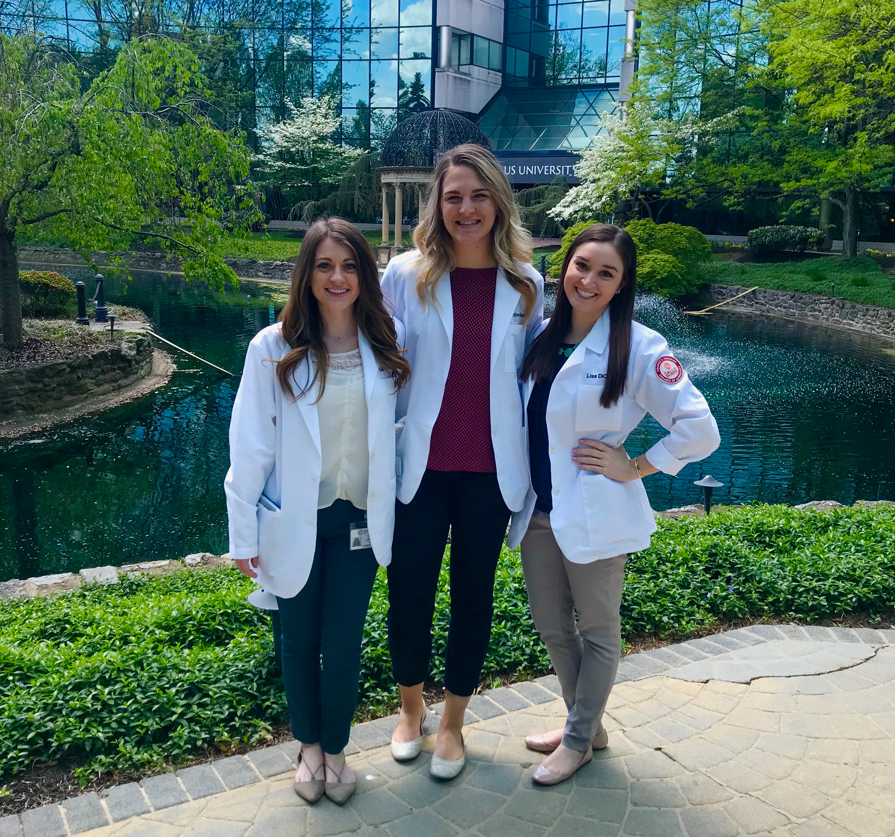 Payton Burke and 2 classmates outside of the Salus main entrance