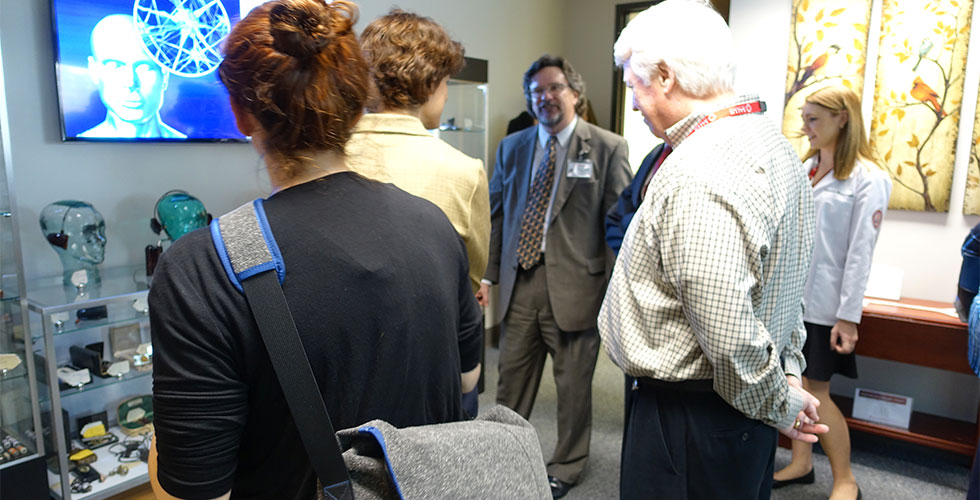 dr. bray showing hearing aid museum