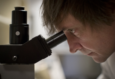 Man looking into a microscope