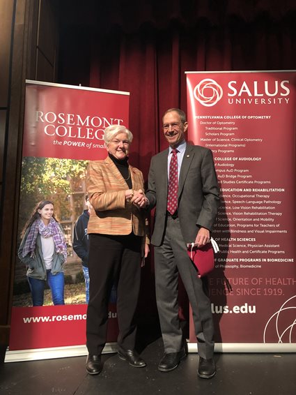 Michael Mittelman shaking hands with Rosemont president