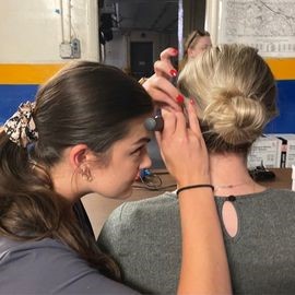 Audiology student conducting a hearing screening on a patient