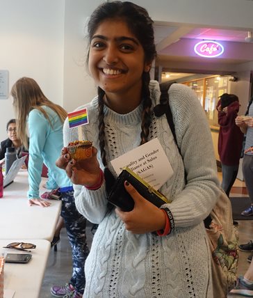 student holding a muffin