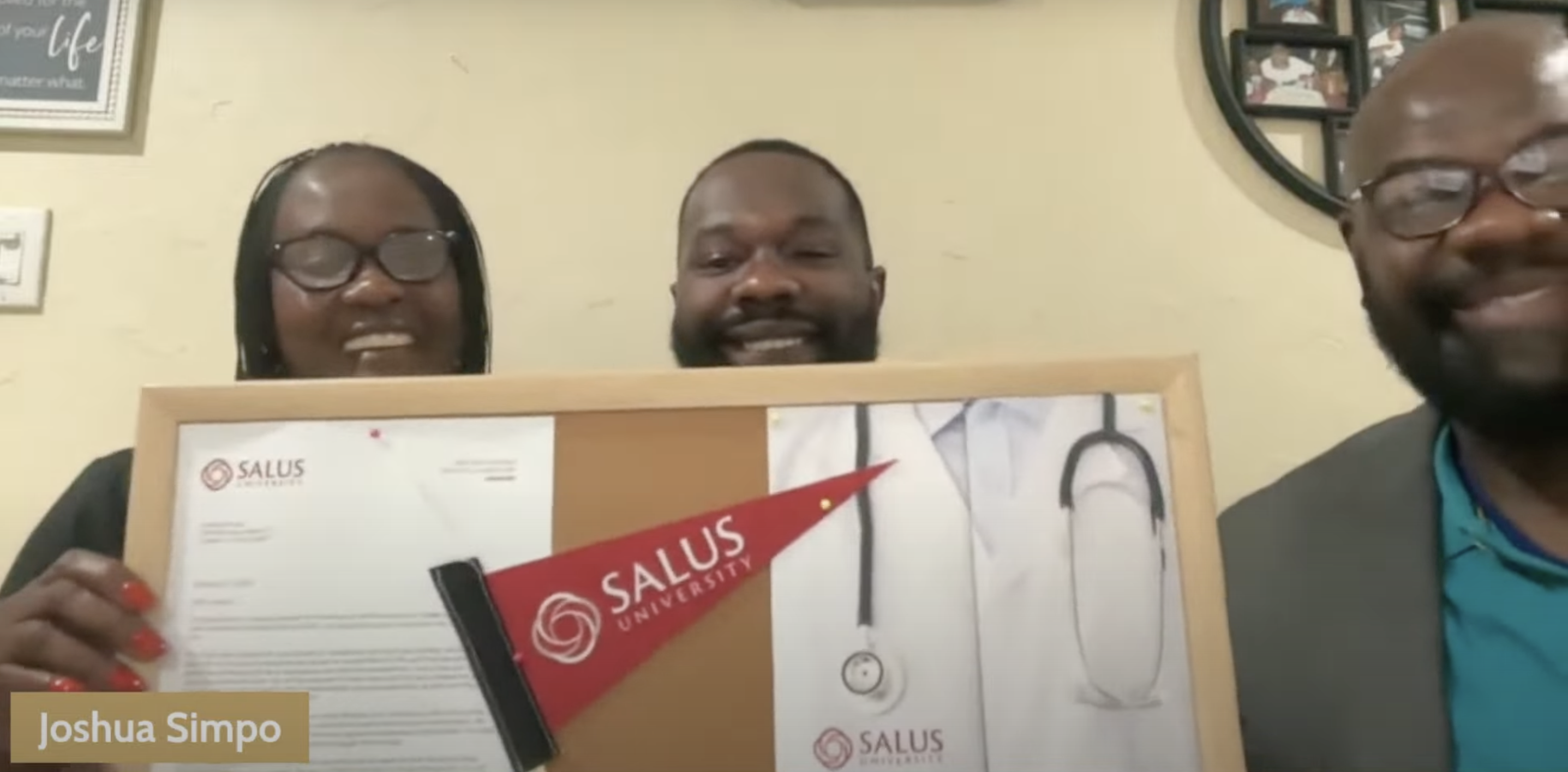 Simpio and mother holding Salus sign