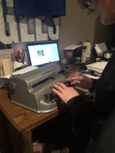 Sheri Hoofers typing on a Perkins Brailler