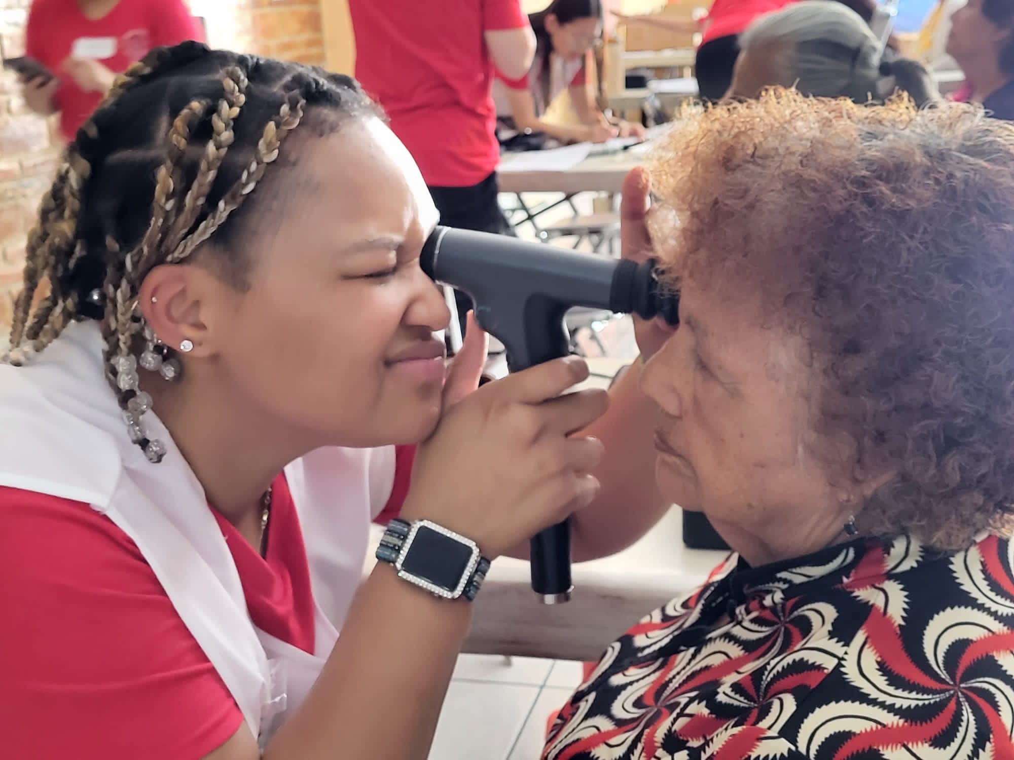 SOSH student providing an eye exam