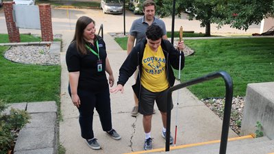 Reuss working with patient to navigate stairs