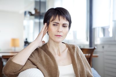 woman touching her ear