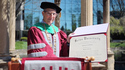 Dr. Mittelman holding an honorary degree