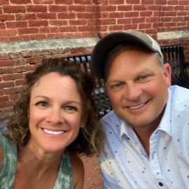 Jeffrey Quelet shown smiling with wife to his left