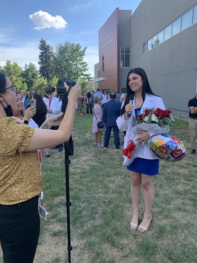 Student in white coat has photo taken