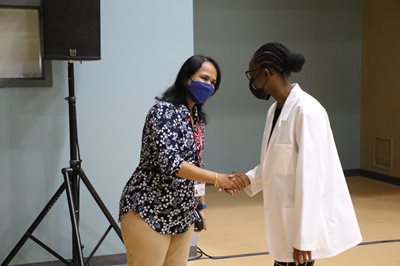 Dr. Aravamudhan congratulates white coat student