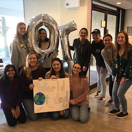 OT students holding "OT" balloons