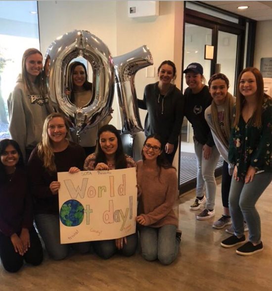 OT students holding "OT" balloons