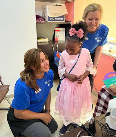 Yasmin Battet with colleague and young patient