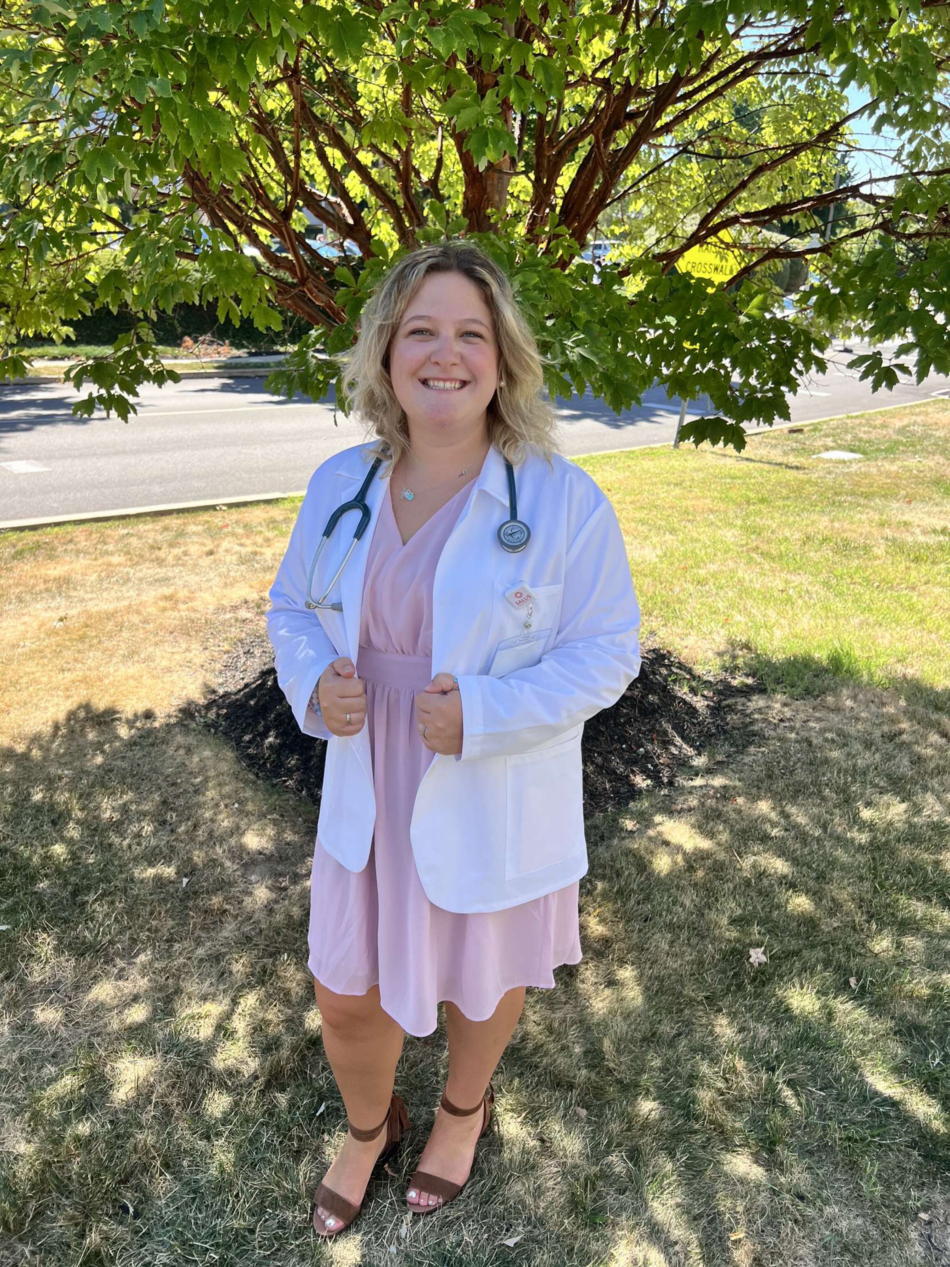 Abby headshot wearing her white coat