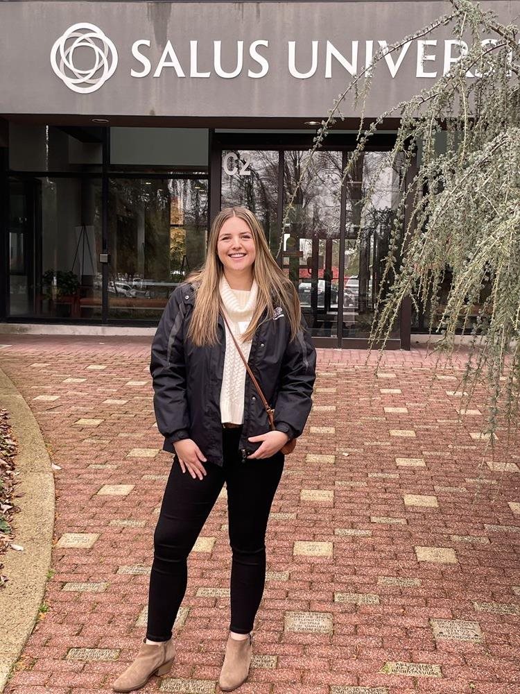 Abby Williams standing outside the Salus main entrance