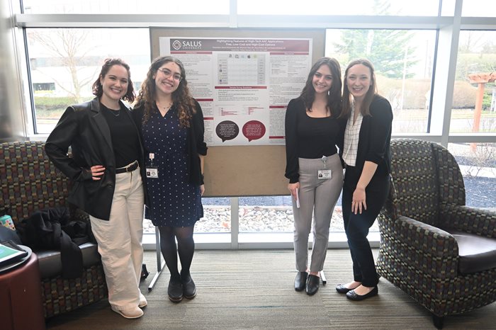 Alexa and fellow SL{ students standing in front of their capstone poster