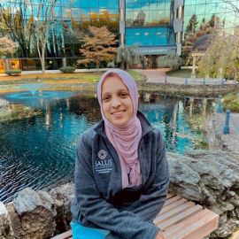 Ayah sitting in front of the Salus pond