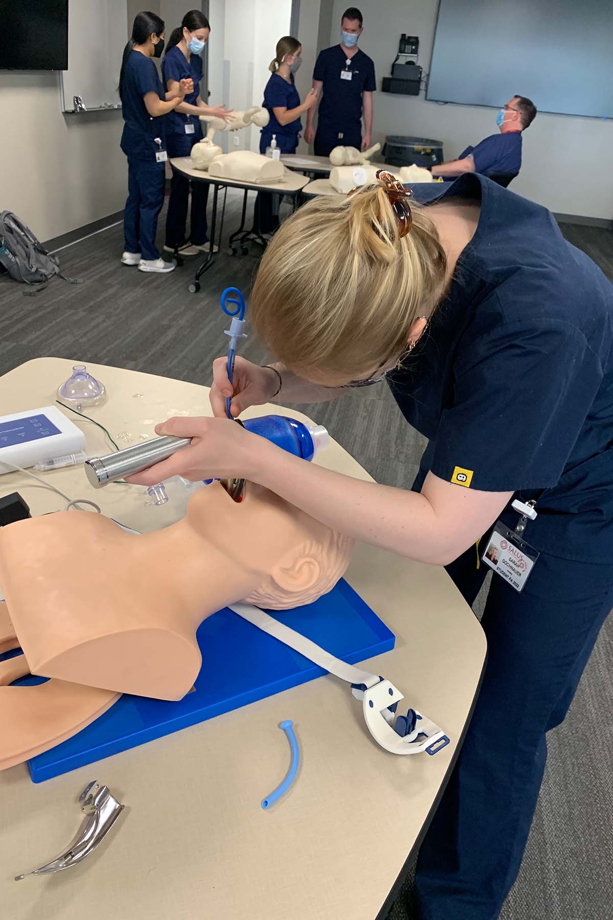 Photo of Sarah Gochnauer practicing intubating a patient during ACLS training