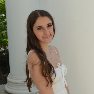 Jackie wearing a white dress